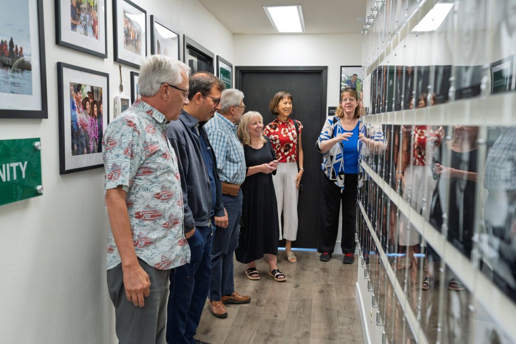 Past presidents of the Alumni Association reminisce as they look at the updated Presidential Wall.
