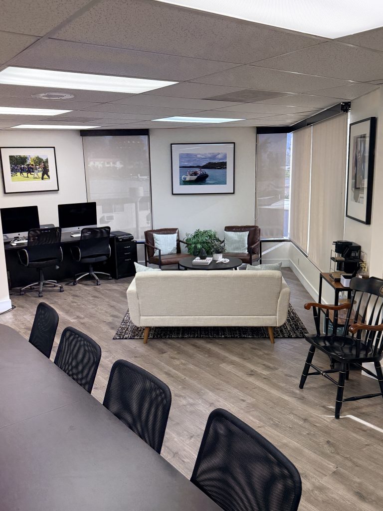 The redesigned Wilfred J. Snodgrass ’38 Conference Room includes a comfortable seating area, hot drink dispenser, volunteer desk, conference table, and  updated shelving for the student lending library.