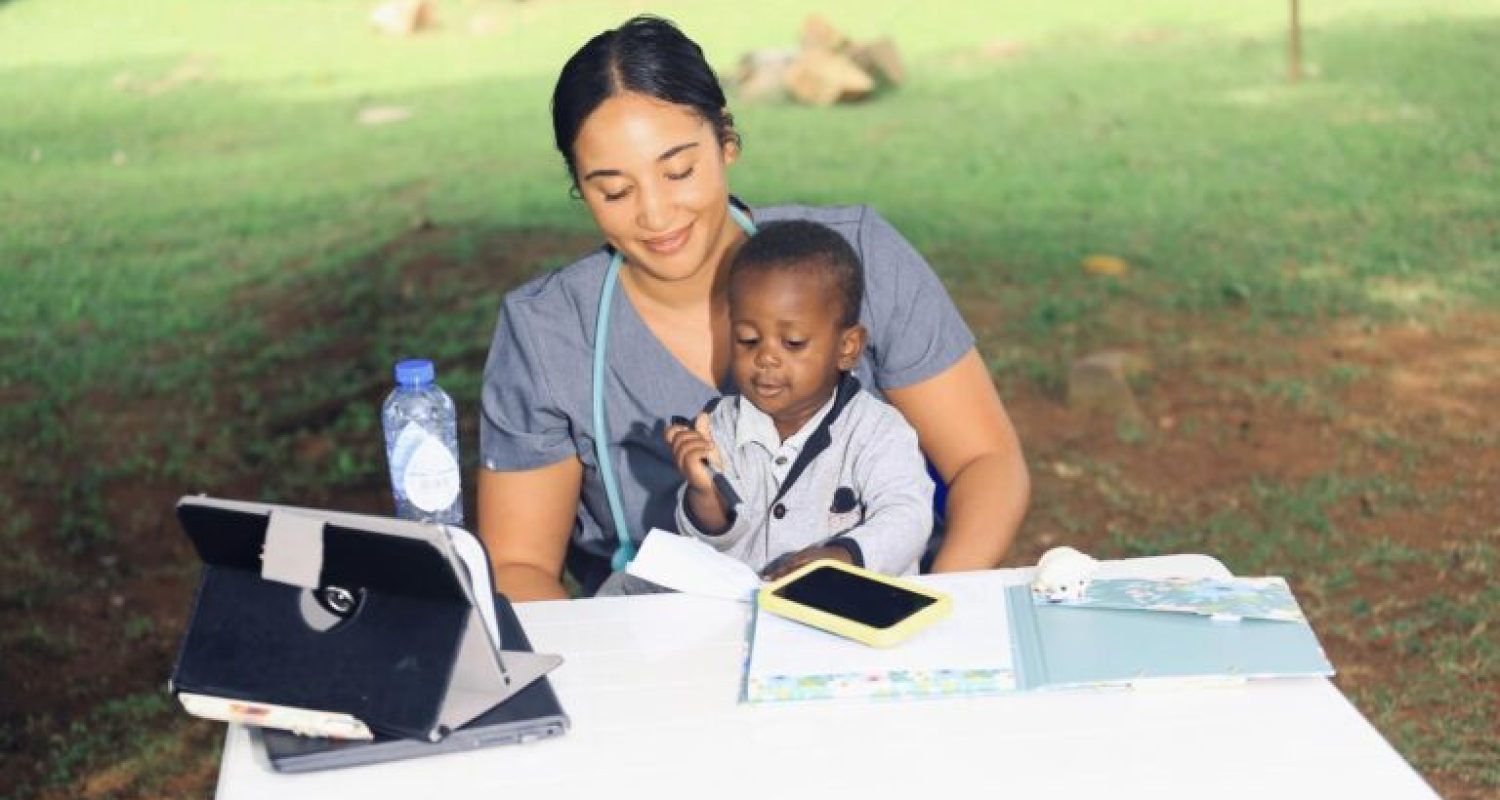 uganda2-768×512 BRIANA GREENE ’23 writing prescriptions with an extra special assistant at Bugema University Hospital in Uganda during her Loma Linda University SIMS mission trip ’23.