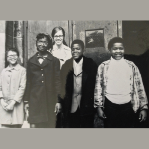 Mary Cray standing behind 4 or her students.