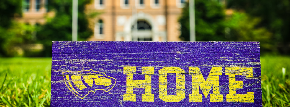 Old Main with a sign that reads HOME