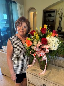 Dianne Somers with a vase of flowers