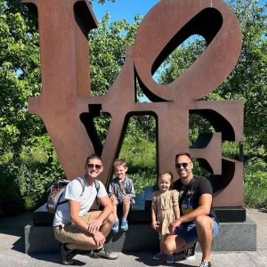 Photo of Steven Heller and family in front of a sculpture that reads LOVE
