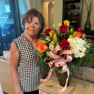 Dianne Somers with a vase of flowers