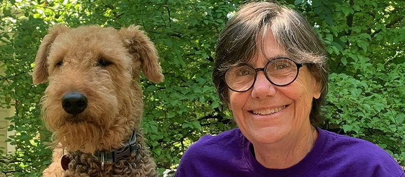 Susie Kaeser ’69 poses with her dog.