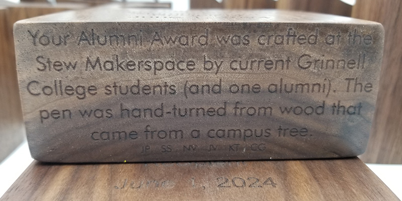 A note on the bottom of the awards. Text: Your Alumni Awrds was crafted at the Stew Makerspace by current Grinnell students. The pen was hand-turned from wood that came from a campus tree.