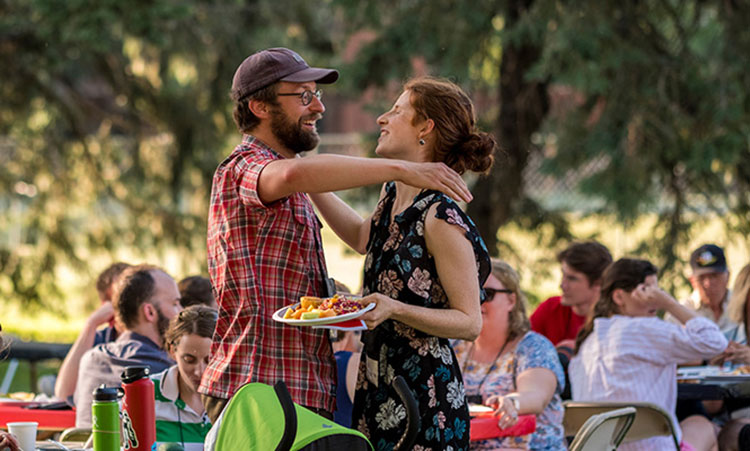 Two alums come together for a hug during the All-Reunion picnic.
