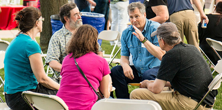 A group of Reunion attendees chat at the All Reunion Social on Saturday.