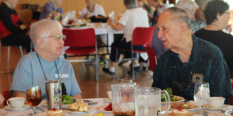 Arthur Dercksen ’54, right, shares a story with Jan Ashley Bowen ’59.