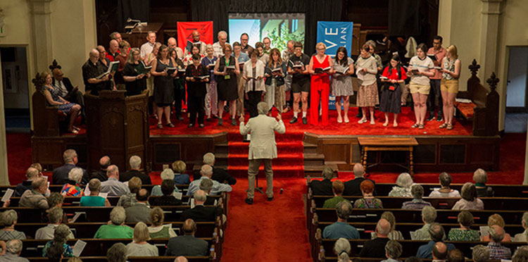 Alumni Choir on the stage of Herrick Chapel during Alumni Assembly.