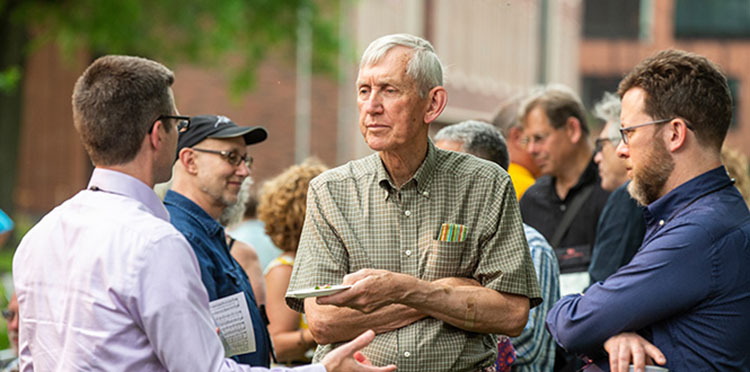 Tom Moore, professor emeritus of mathematics and statistics, socializes with Reunion attendees.