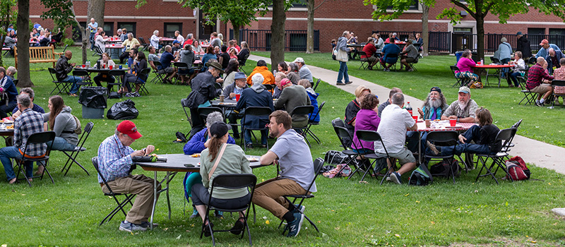 Alumni eat and socialize during All Reunion picnic.