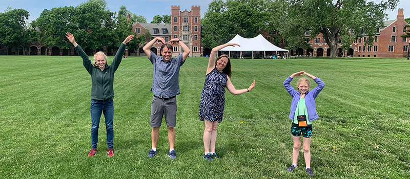 A family attending Reunion complete the "YMCA" in front of Gates Tower.