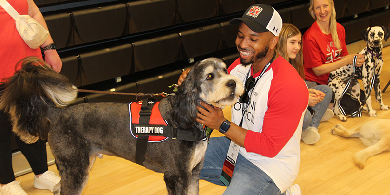 Ben Vaughn Jr. ’15 pets an emotional support dog during the Class of 2015 10th Reunion Brunch.