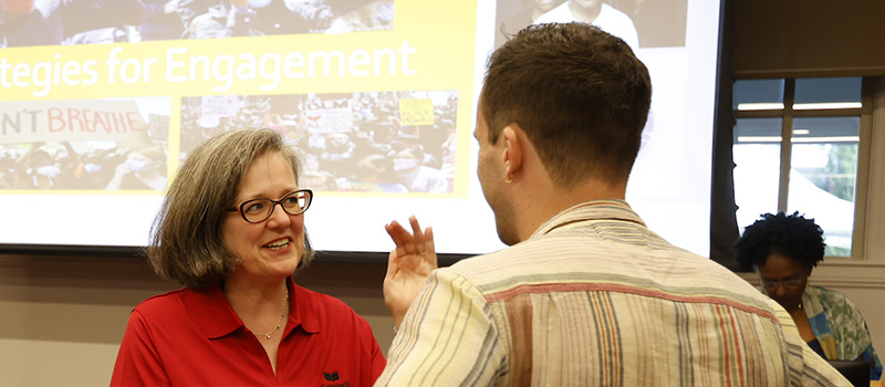 President Anne F. Harris talks to alums.