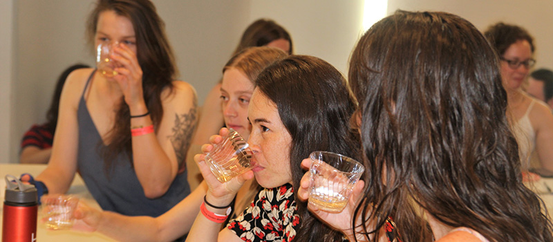 Young alums sample a wine