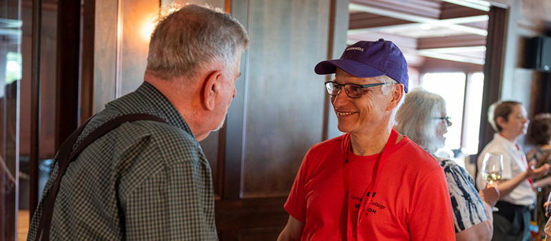 David Calvert ’75 speaks with a classmate.