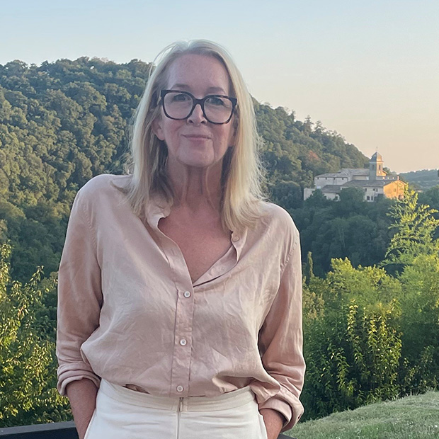 Nikki Carlson ’87 with trees and a historic church in a background.