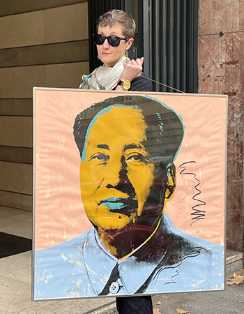 Carlson’s daughter, Adriana, holds up original artwork created by Andy Warhol.