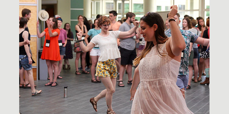 Alumni dance to the music during a cakewalk.