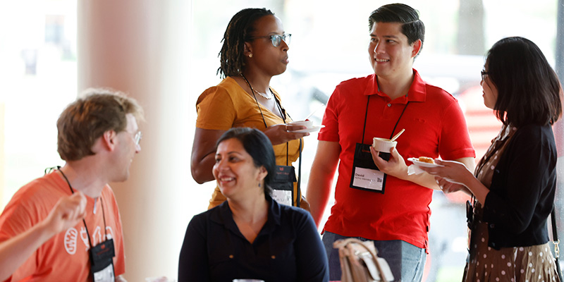 David Achio Mendez '13 talks to Paula Nesbeth '13 and other guests.
