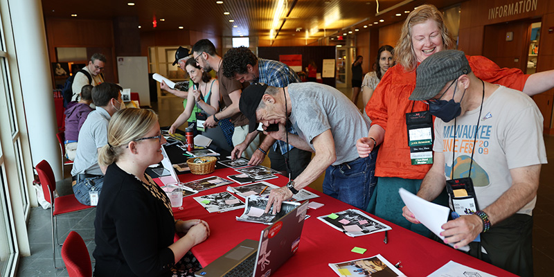 Alumni look through historical pictures to help identify the subjects.