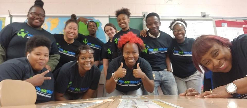 Students in Baltimore who are involved in the Active Children Excel (ACE) Project pose with Susan T. Klumpner ’09.
