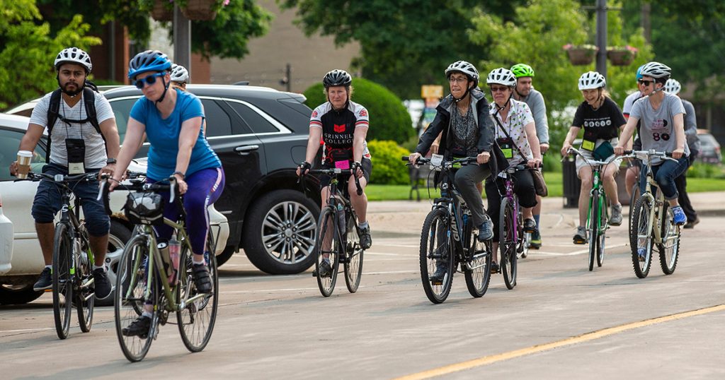 Grinnellians ride bikes through the streets of Grinnell.