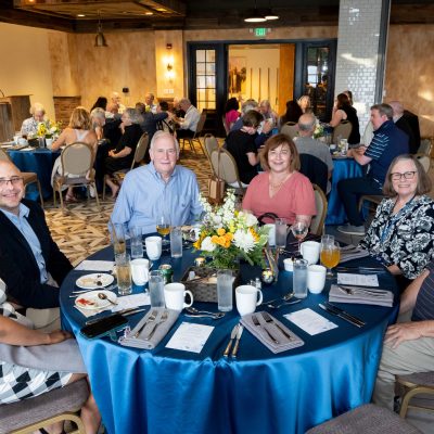 Group seated at banquet table during event