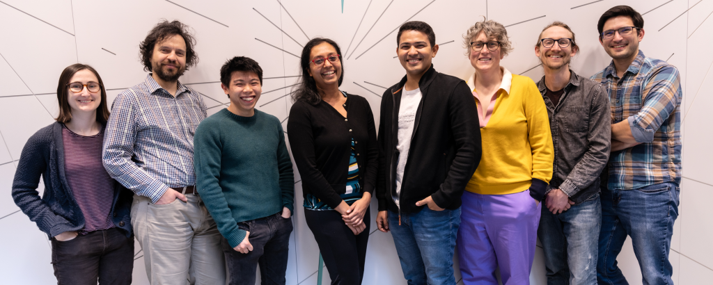 a group of people smiling and giving pose for picture